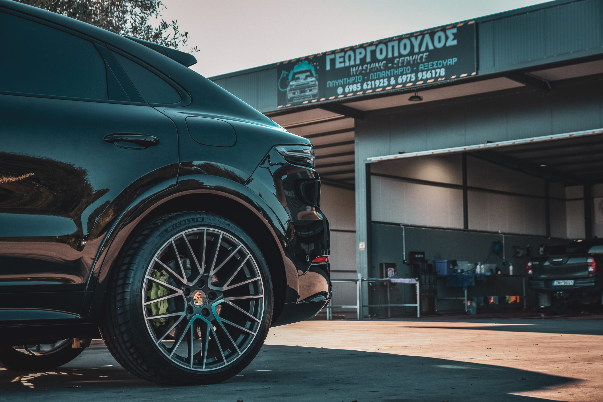 Car photo , primarily focused on the back of the car with background the business.